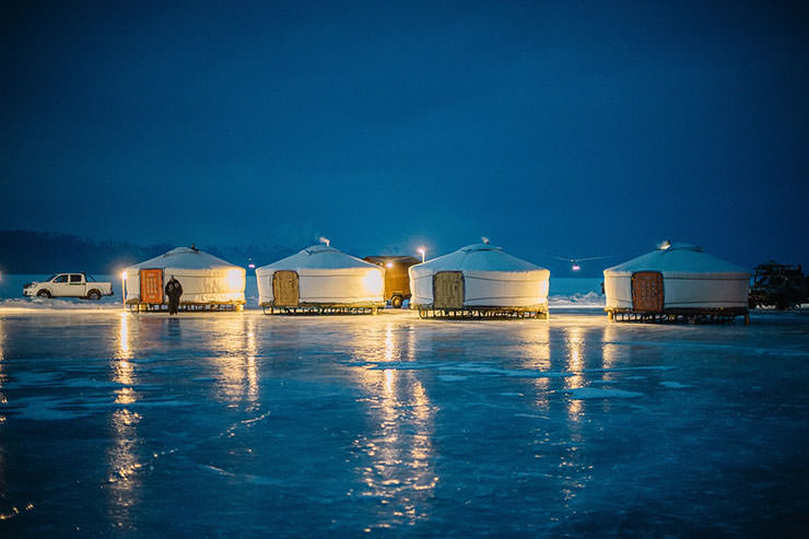 Mongolian yurts placed on the ice of the frozen Lake Baikal, as temporary accommodation for the participants of MadWay Rally, Mad Max-inspired event on the edge of the society.