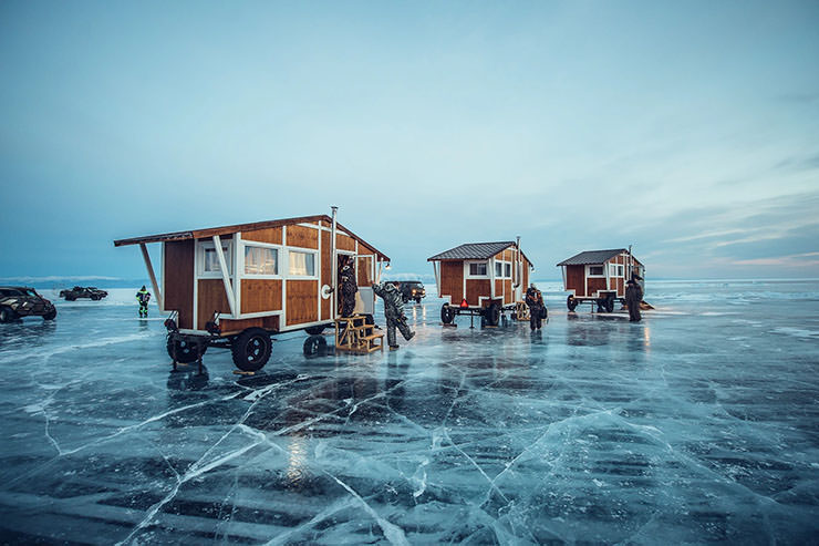 Houses on wheels placed on the frozen Lake Baikal, a sleeping place for the participants of MadWay Rally.