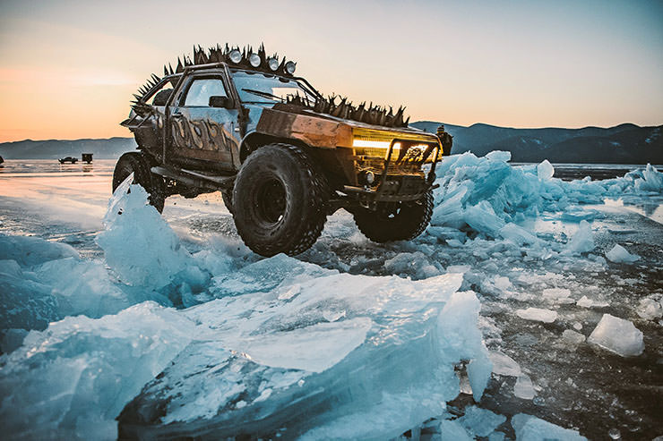 Car with metal spikes in Mad Max style, driving over ice of frozen Lake Baikal during the MadWay Rally.
