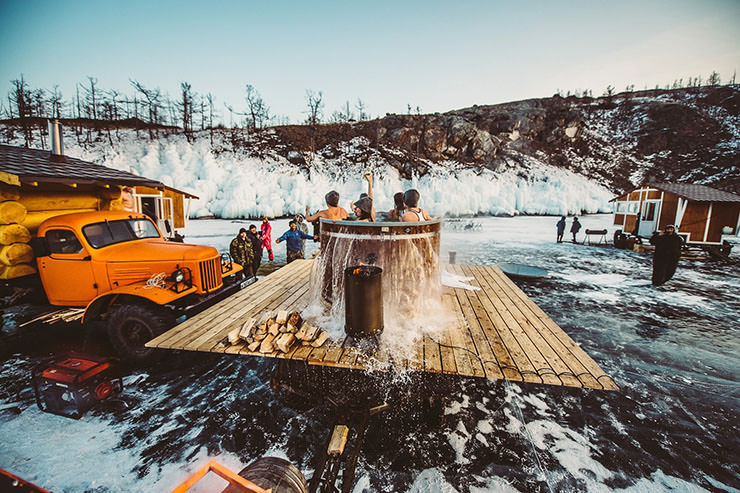 Participants of the MadWay Rally on frozen Baikal Lake enjoying a makeshift communal hot bath.