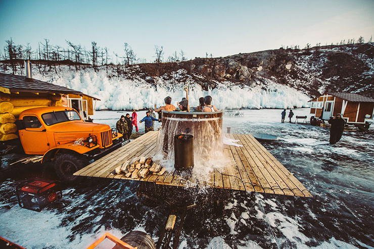 Participants of the MadWay Rally on frozen Baikal Lake enjoying a makeshift communal hot bath.