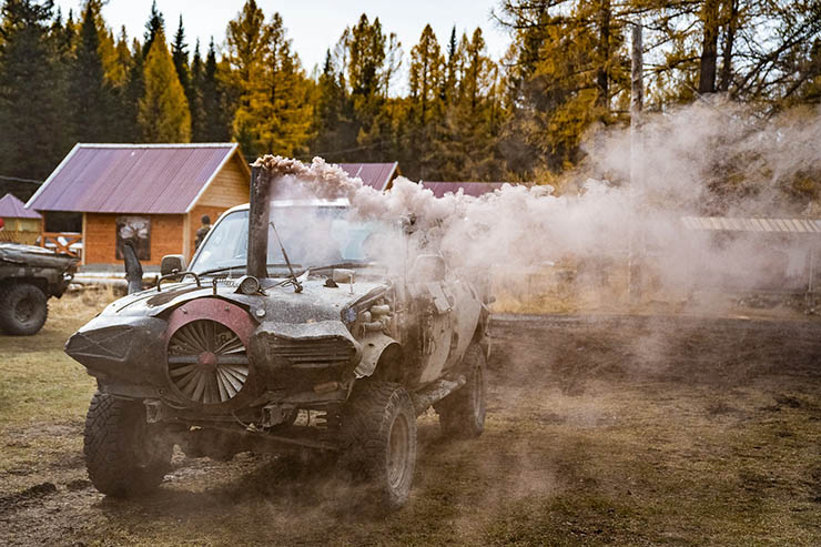 Mad Max-style car producing smoke through a pipe, one of the vehicles in MadWay Rally fleet.