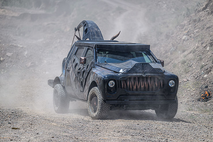 Car with teeth, modified vehicle participating in MadWay Rally in Kyrgyzstan, a real-life Mad Max experience.