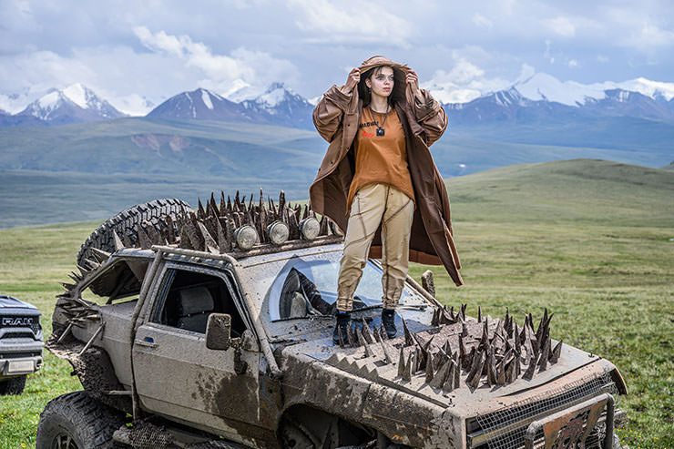 Kristina Gubareva, daughter of Russian-Cypriot businessman Alexey Gubarev, standing on the off-road car with spikes in Mad-Max style, during the MadWay Rally organized by her dad.