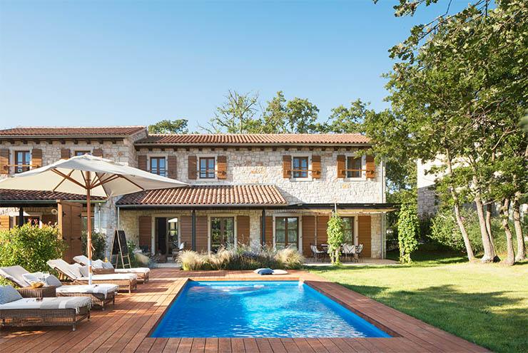 Outdoor swimming pool in front of a three-bedroom villa at Meneghetti Wine Hotel, one of the best honeymoon resorts in Croatia; photo by Meneghetti.