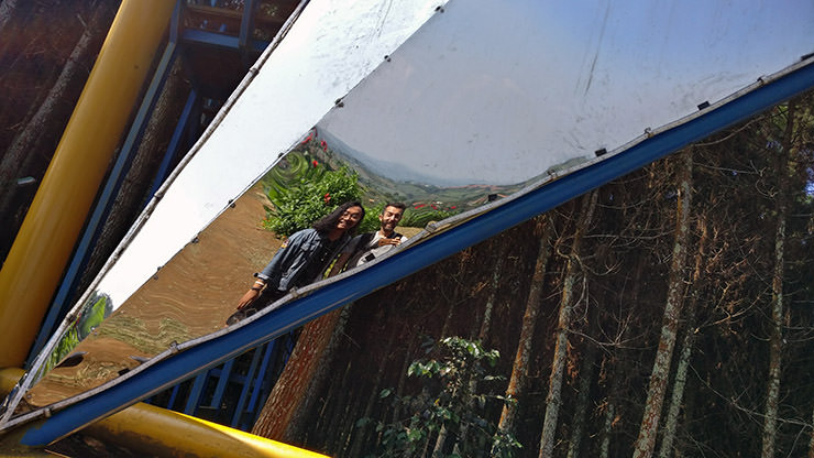 Fathin Naufal and Ivan Kralj looking at their reflection in one of the arms of the Puncak Bintang stars at Bukit Moko, above Bandung, Indonesia; photo by Ivan Kralj.