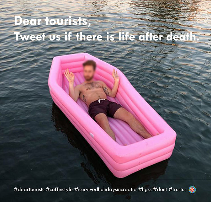 Man in swimming trunks lying in a coffin-shaped floaty on water, with a message "Dear tourists, tweet us if there is life after death"; humorous safety marketing campaign by Croatian Mountain Rescue Service - Hrvatska gorska služba spašavanja - HGSS.