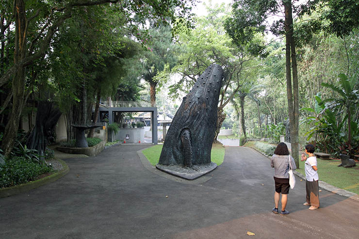 Fathin Naufal and his friend Nana standing next to a whale sculpture at NuArt Sculpture Park in Bandung, Indonesia; photo by Ivan Kralj.