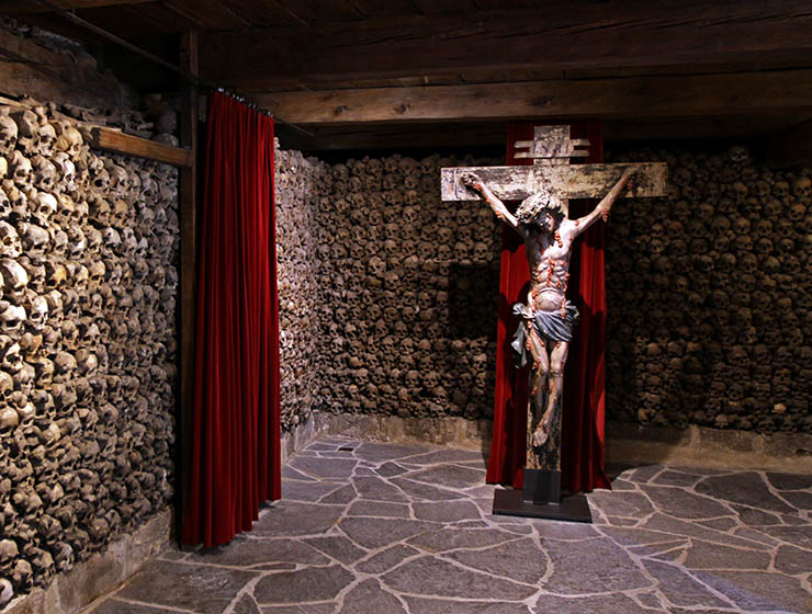 Crucifix with bleeding Jesus as a centerpiece of Beinhaus Leuk, Swiss charnel house with 22,000 skulls; photo by Ivan Kralj.