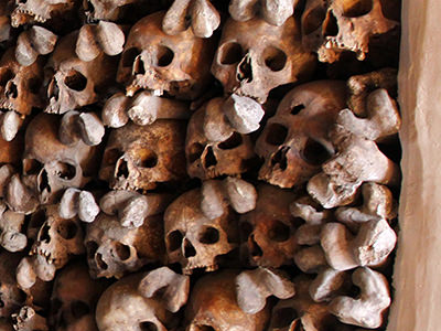 Skull in the skull wall of Leuk Charnel House, with a visible bullet hole, believed to belong to the participant of the Battles of Pfyn in 1798-1799 against the troops of French Revolution; photo by Ivan Kralj.