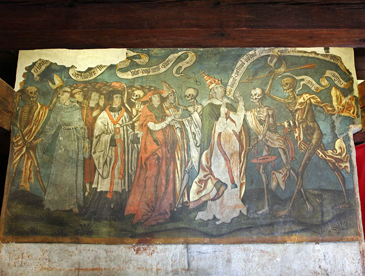 Danse Macabre fresco in Beinhaus Leuk, Renaissance artwork showing skeletons attacking a Pope, a cardinal, a bishop, and other clergy members; photo by Ivan Kralj.