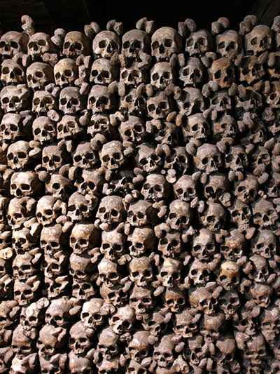 The skulls and thigh bones stacked on each other, forming a wall of the Beinhaus Leuk, a fascinating ossuary in southern Switzerland; photo by Ivan Kralj.