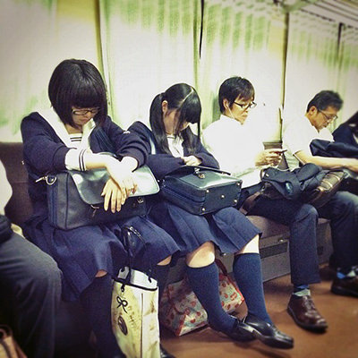 Japanese custom of inemuri, the art of napping in public - sleepy passengers on a train to Iga; photo by John Gillespie.