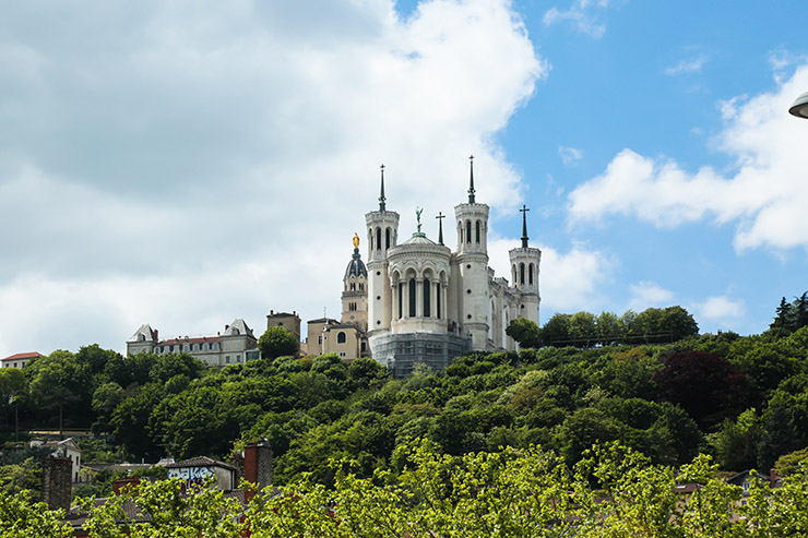 Basilica of Notre-Dame de Fourvière on the hill in Lyon, has a nickname "the upside-down elephant" because of its towers resembling elephant's legs lifted in the air; photo by Salya T, Unsplash.