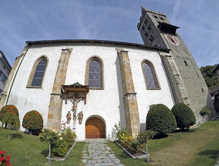 The exterior of the Church of Saint Stephan in Leuk, with a belfry and an entrance to Beinhaus Leuk, the ossuary containing 22,000 human skulls; photo by Ivan Kralj.