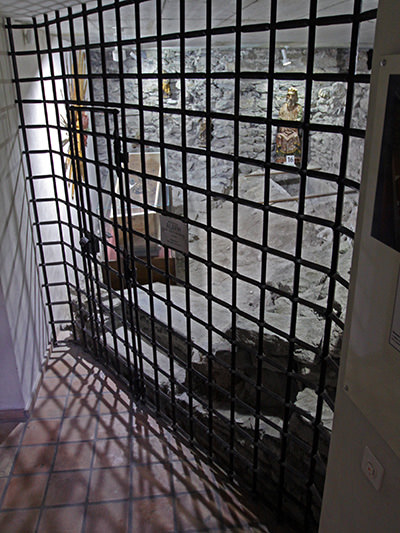 The crypt in St. Stephen's Church in Leuk, protecting valuable sacral artworks and Leuk Mummy behind alarmed bars; photo by Ivan Kralj.