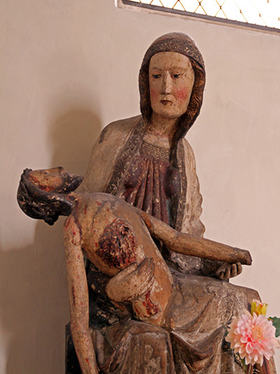 Valuable early 14th-century Pieta found in Leuk Charnel House during the 1982 renovations, now displayed inside the St. Stephan's Church, Switzerland; photo by Ivan Kralj.