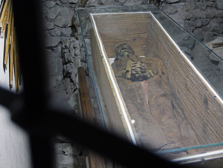 The Woman from Leuk, a mummy that was discovered in 1982 during the renovation of St. Stephan's Church, displayed in the original wooden coffin, with glass cover; photo by Ivan Kralj. 