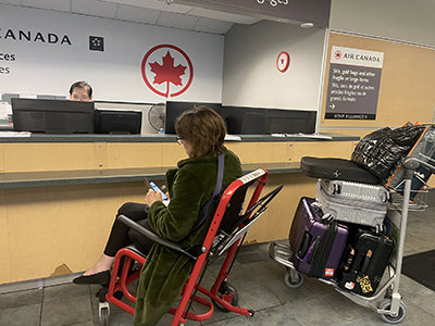 Stephanie Cadieux, Canada’s chief accessibility officer, whose wheelchair was forgotten at departure, waiting at Air Canada desk to resolve the matter; private album. 
