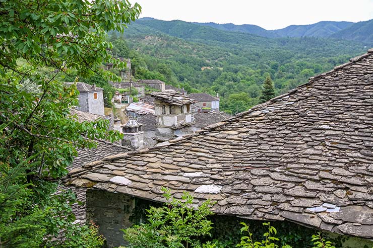 The slate roofing of the stone house in the village of Kipoi, surrounded by green landscape, one of the 46 stone villages in Zagori, Epirus, Greece; photo by Ivan Kralj.