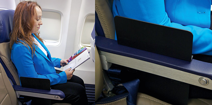 Create-a-Space seat divider for planes, that ensures you get your half of the armrest, and nobody invades your personal space; photo by Create-a-Space.