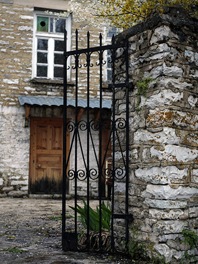 A door into a courtyard of a stone house in Vradeto, a village in Zagorochoria, Greece; photo by Dimitris Kilymis.