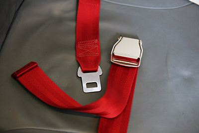 Red-colored airplane seat belt; photo by Daniel Schwen.