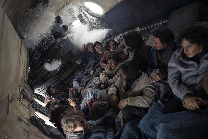 Scene from Netflix movie "Society of the Snow" in which avalanche penetrates the fuselage where the victims of Flight 571 crash found refuge from harsh Andes environment.