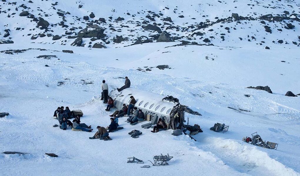 Society of the Snow, a group of Uruguayan rugby players, survivors of a 1972 plane crash in snow-covered Andes, Netflix movie (2023).
