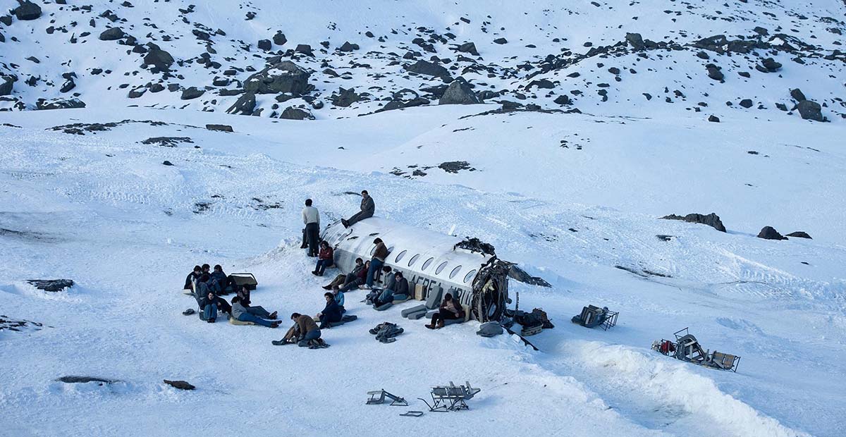Society of the Snow, a group of Uruguayan rugby players, survivors of a 1972 plane crash in snow-covered Andes, Netflix movie (2023).