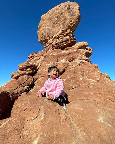 Toddler Journey Castillo posing on the rock at the Arches National Park, one of the 63 US national parks she would visit before her third birthday.