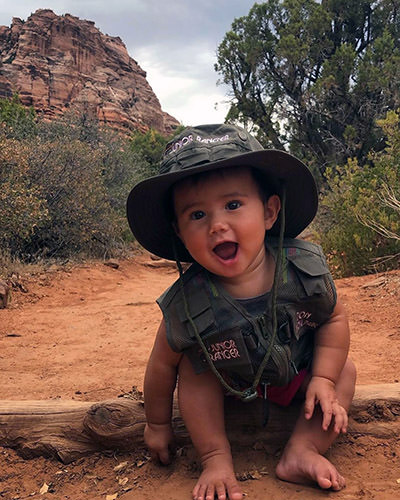 Baby Journey Castillo dressed like a junior park ranger at Zion National Park, one of the 63 national parks she would visit before her third birthday.
