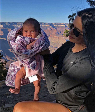 Valerie Castillo holding her newborn 15-day-old Journey Castillo while visiting the Grand Canyon, the first of 63 national parks in the USA the kid will see before the age of 3.