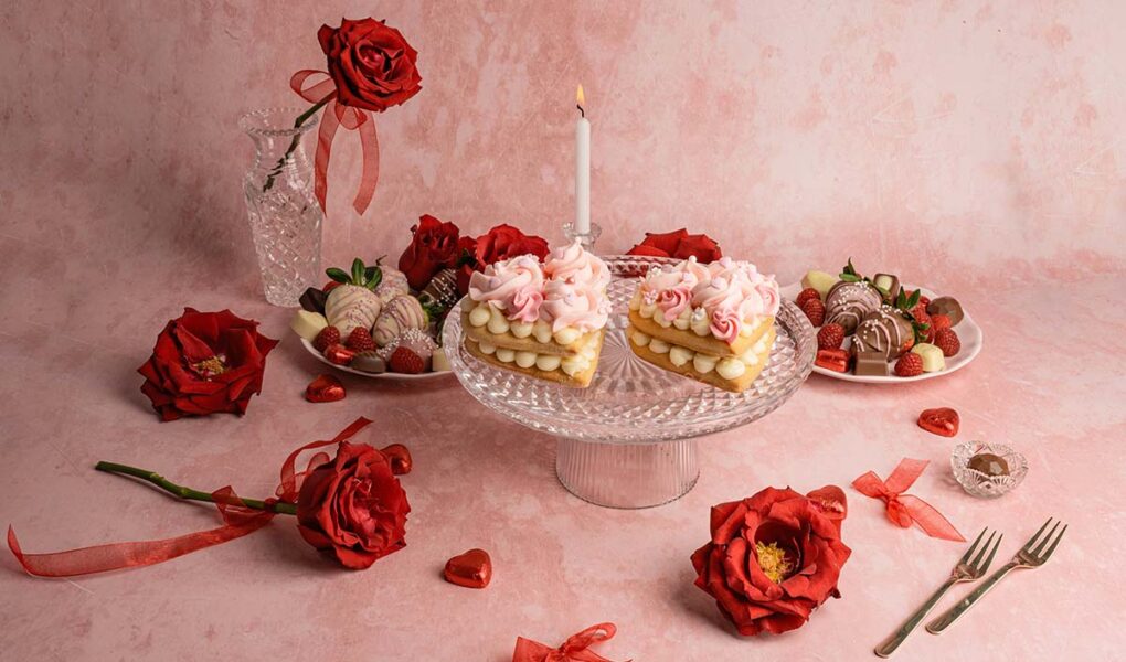Studio shot of heart-shaped cakes and roses, all in red and pink tones, as Valentine food gift ideas concept; photo by Anita Austvika, Unsplash.
