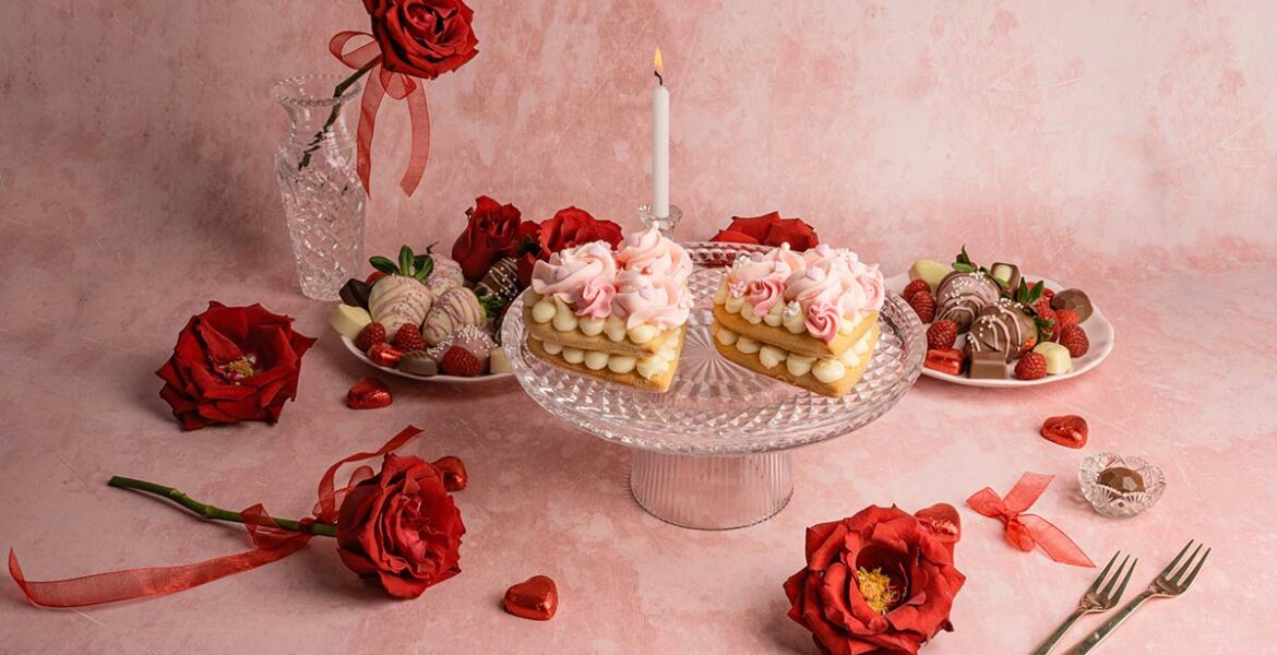 Studio shot of heart-shaped cakes and roses, all in red and pink tones, as Valentine food gift ideas concept; photo by Anita Austvika, Unsplash.