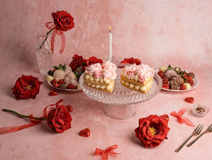 Studio shot of heart-shaped cakes and roses, all in red and pink tones, as Valentine food gift ideas concept; photo by Anita Austvika, Unsplash.