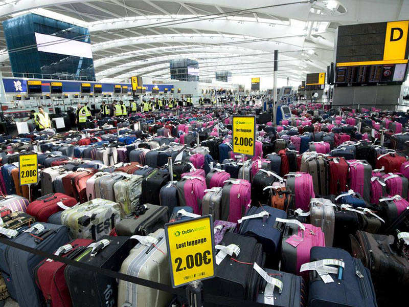 Airport terminal full of suitcases with yellow sign advertising lost luggage sale for 2 euros, with Dublin Airport logo; one of many lost luggage scams that appeared on Facebook.