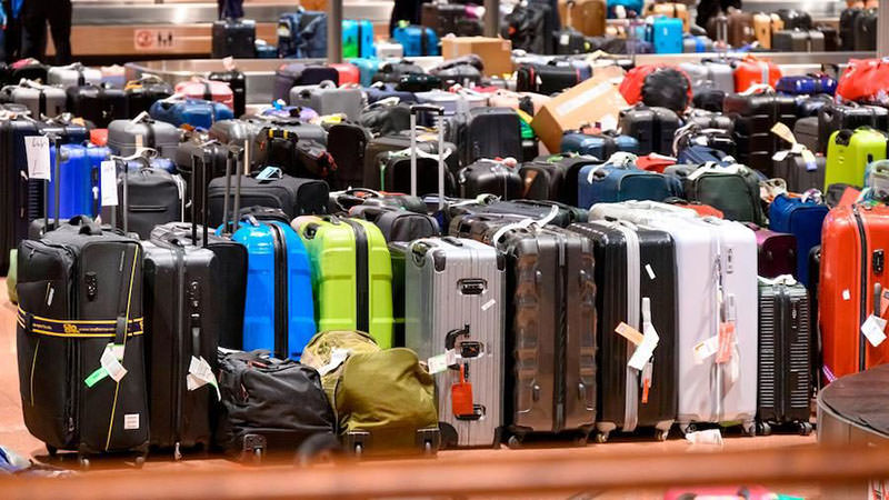 Thousands of suitcases lined up at the baggage claim area at Tango terminal of Hamburg Airport during the disruptions of international air traffic in the summer of 2022. This photo was used and edited for several lost luggage scams on Facebook, advertising fake baggage sales. The author of the original photograph is Jonas Walzberg / DPA.