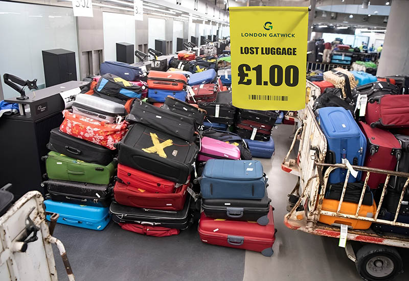 Edited photograph of a fake unclaimed baggage sale at London Gatwick Airport, offering a suitcase for a price of £1; one of the lost luggage scams that tricked Facebook users in handing over credit card details to fraudsters. The actual scene in this stolen and photoshopped image is shot at Frankfurt Airport by a photographer Boris Roessler / DPA.