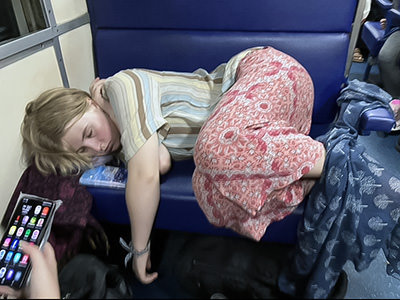 Rosa curled up on a train on the slow trip to Australia.