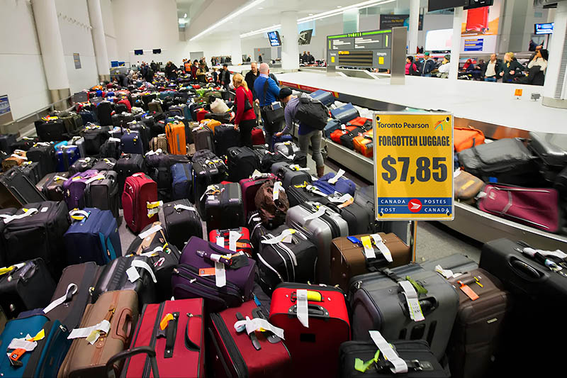 Suitcases lined up at what pretends to be Toronto Pearson International Airport, and a forgotten baggage sale for $7.85 per piece; another lost luggage scam that appeared on Facebook.