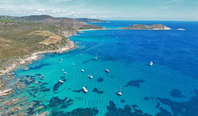 French Riviera or Cote d' Azur, one of the best places to visit in the South of France, aerial view of boats anchored in the azure waters of the coastline; photo by Julius Hildebrandt, Unsplash.