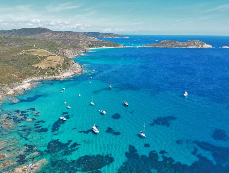 French Riviera or Cote d' Azur, one of the best places to visit in the South of France, aerial view of boats anchored in the azure waters of the coastline; photo by Julius Hildebrandt, Unsplash.