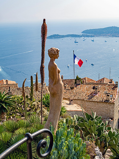 Woman statue in the Botanical Garden of Eze, a beautiful medieval village in the French Riviera, with the Mediterranean Sea in the background; photo by V2F, Unsplash. 