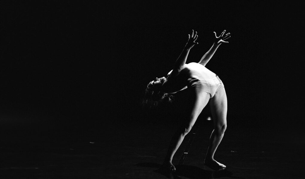 Late Angela Laurier, French-Canadian contortionist bending her spine in her performance "Deversoir" during the Festival Novog Cirkusa in Zagreb, Croatia; black-and-white photo by Jean Pierre Estournet.
