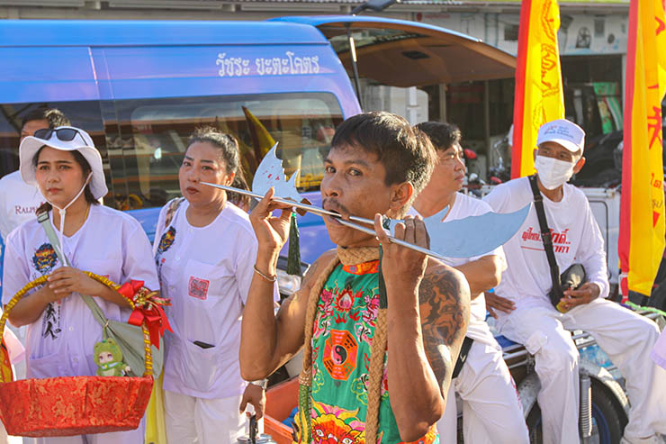 A man with two metal pieces of weapon passing through his pierced cheeks and mouth, at Jor Soo Goong Naka Shrine, during Jay or Phuket Vegetarian Festival, also known as Thailand's self-mutilation festival; photo by Ivan Kralj.
