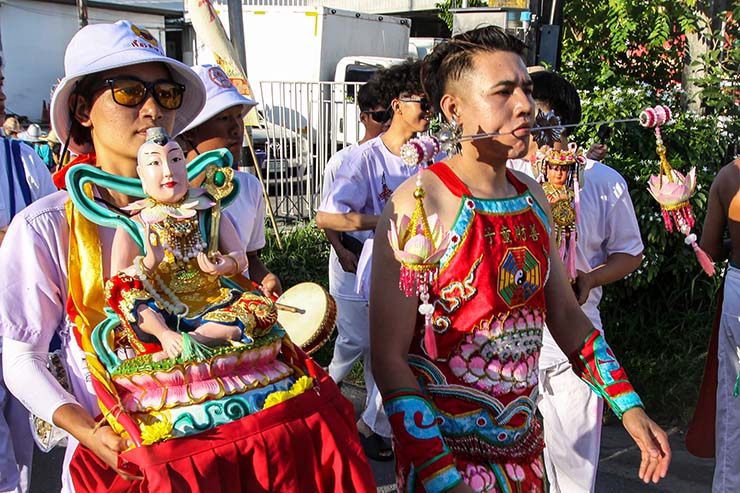 A man with pierced cheeks walking in a street procession through Phuket during Jay or Vegetarian Festival, also known as Thailand's self-mutilation festival; photo by Ivan Kralj.
