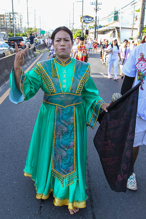 A woman with pierced cheeks in a street procession through Phuket during Jay or Vegetarian Festival, also known as Thailand's self-mutilation festival; photo by Ivan Kralj.