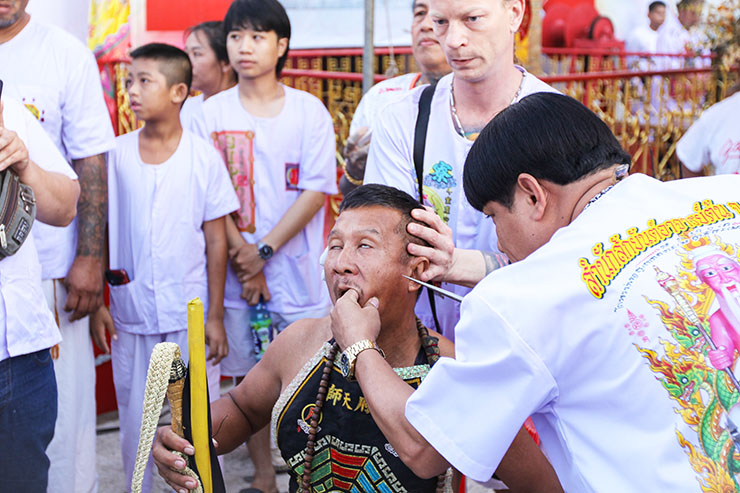 Ma song spirit medium getting pierced at Jor Soo Goong Naka Shrine in Phuket, the starting point of one of the street processions at the Phuket Vegetarian Festival, also known as Thailand's self-mutilation festival; photo by Ivan Kralj.