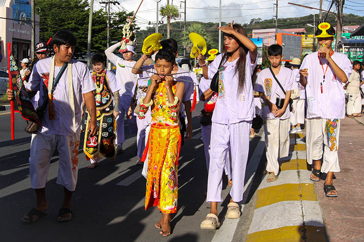 A young boy with pierced cheeks, walking in a street procession through Phuket during Jay or Vegetarian Festival, also known as Thailand's self-mutilation festival; photo by Ivan Kralj.
